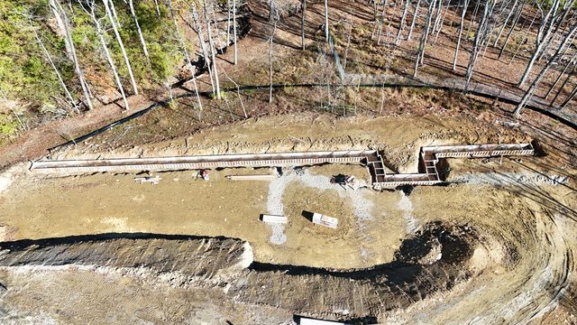 High angle overview of poured retaining wall for hillside slope